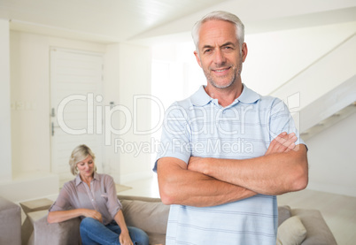 Smiling man with man sitting on couch at home