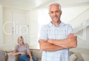 Smiling man with man sitting on couch at home