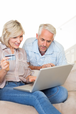 Mature couple doing online shopping at home