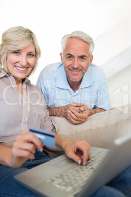 Mature couple doing online shopping at home