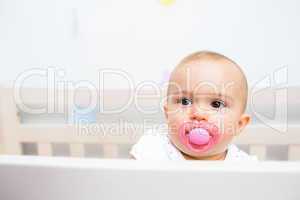 Closeup of a cute baby with pacifier in mouth