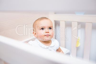Closeup of a cute baby looking up in crib