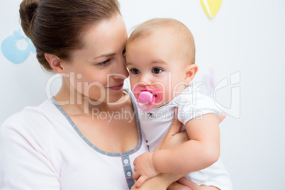Closeup of mother and baby with pacifier