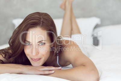 Closeup of a pretty smiling woman lying in bed