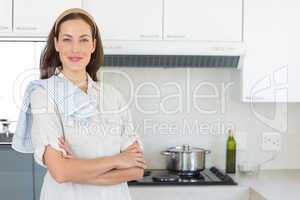 Portrait of a confident smiling woman in kitchen