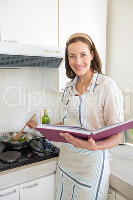 Portrait of smiling woman preparing food in kitchen