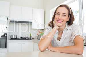 Portrait of a smiling young woman in kitchen