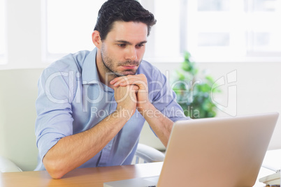 Businessman looking at laptop