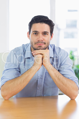 Businessman leaning on desk
