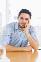 Businessman leaning on office desk