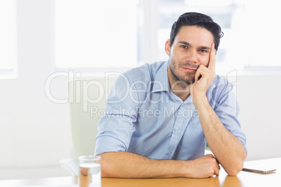 Confident businessman sitting at desk