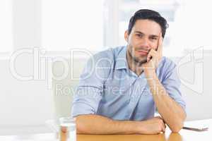 Confident businessman sitting at desk