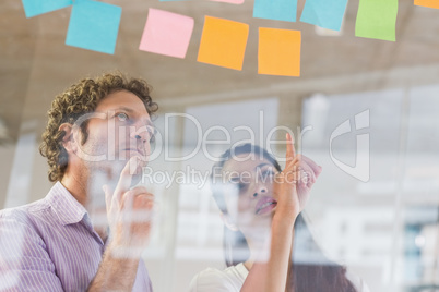 Business people looking at adhesive notes