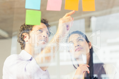 Business people reading adhesive notes