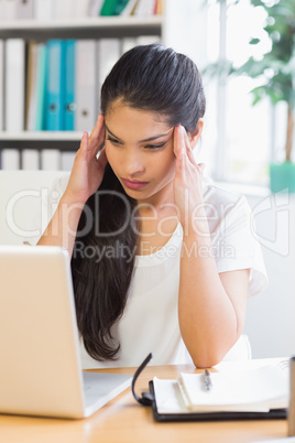 Frustrated businesswoman looking at laptop