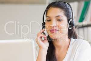 Businesswoman using headset in office