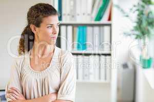 Businesswoman with arms crossed looking away
