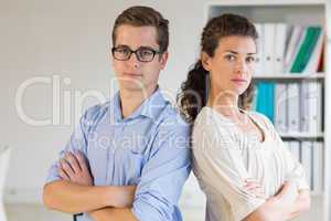 Confident businessman and woman in office