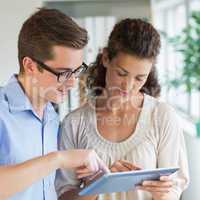 Businessman and businesswoman using digital tablet