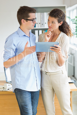 Business people discussing over digital tablet