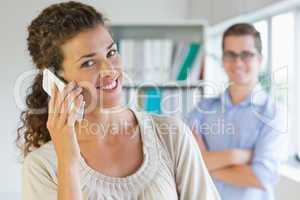 Businesswoman using mobile phone in office