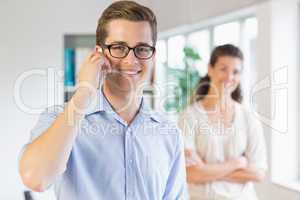 Businessman using cellphone in office