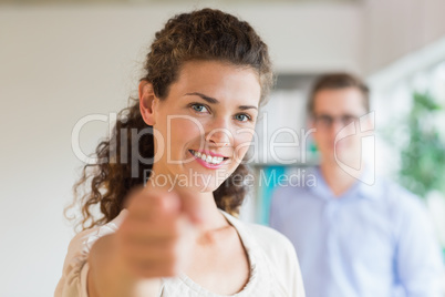 Confident businesswoman pointing in office