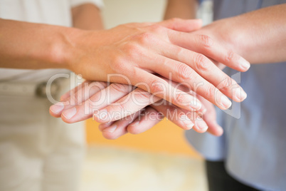 Business people stacking hands