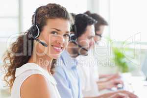 Call center operator wearing headset in office