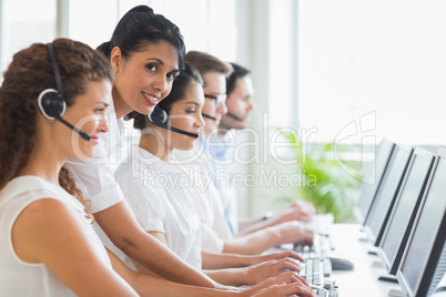 Manager checking her staffs work in call center