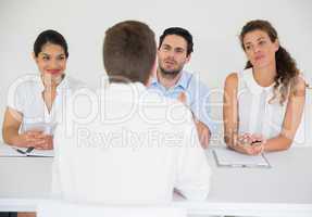 Man being interviewed by business people