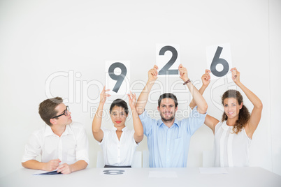 Business people holding score signs