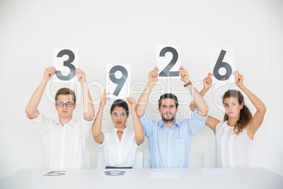 Business people holding score cards