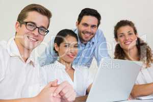 Confident business people with laptop