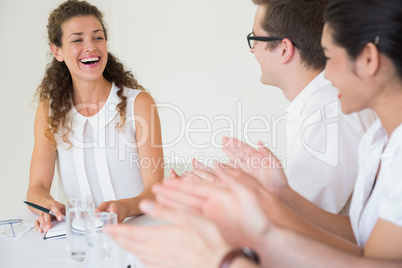 Business people applauding for businesswoman