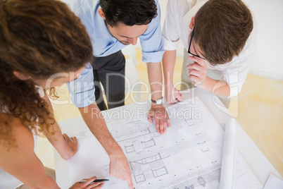 Business people studying blueprint