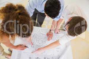 Business people analyzing blueprint