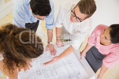 Business people discussing over blueprint
