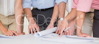 Business people working on blueprint Business people working on blueprint