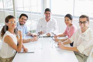 Smiling business people at conference table