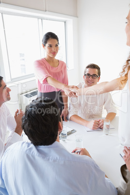 Businesswomen shaking hands during meeting