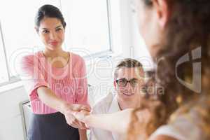 Businesswoman shaking hands with female partner