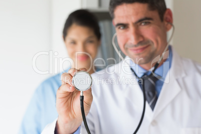 Smiling doctor holding stethoscope