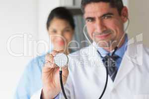 Smiling doctor holding stethoscope