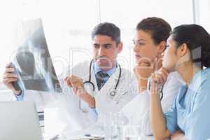 Male doctor discussing xray with colleagues