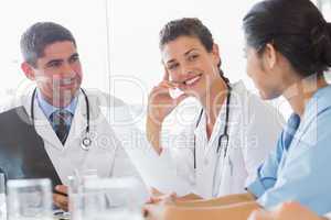 Doctor discussing with nurse and colleague