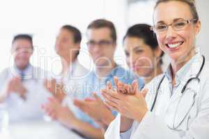 Happy doctor and team clapping