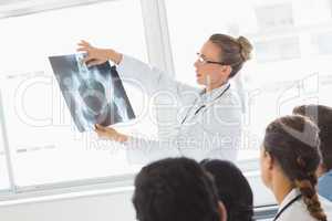 Doctor explaining Xray to colleagues