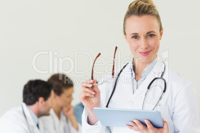 Doctor holding digital tablet and glasses Doctor holding digital tablet and glasses
