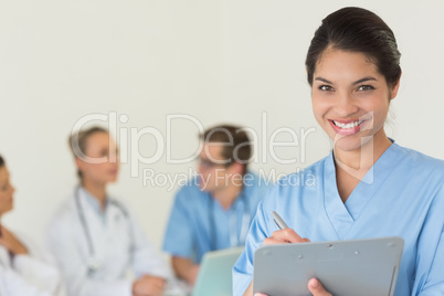 Beautiful nurse holding clipboard